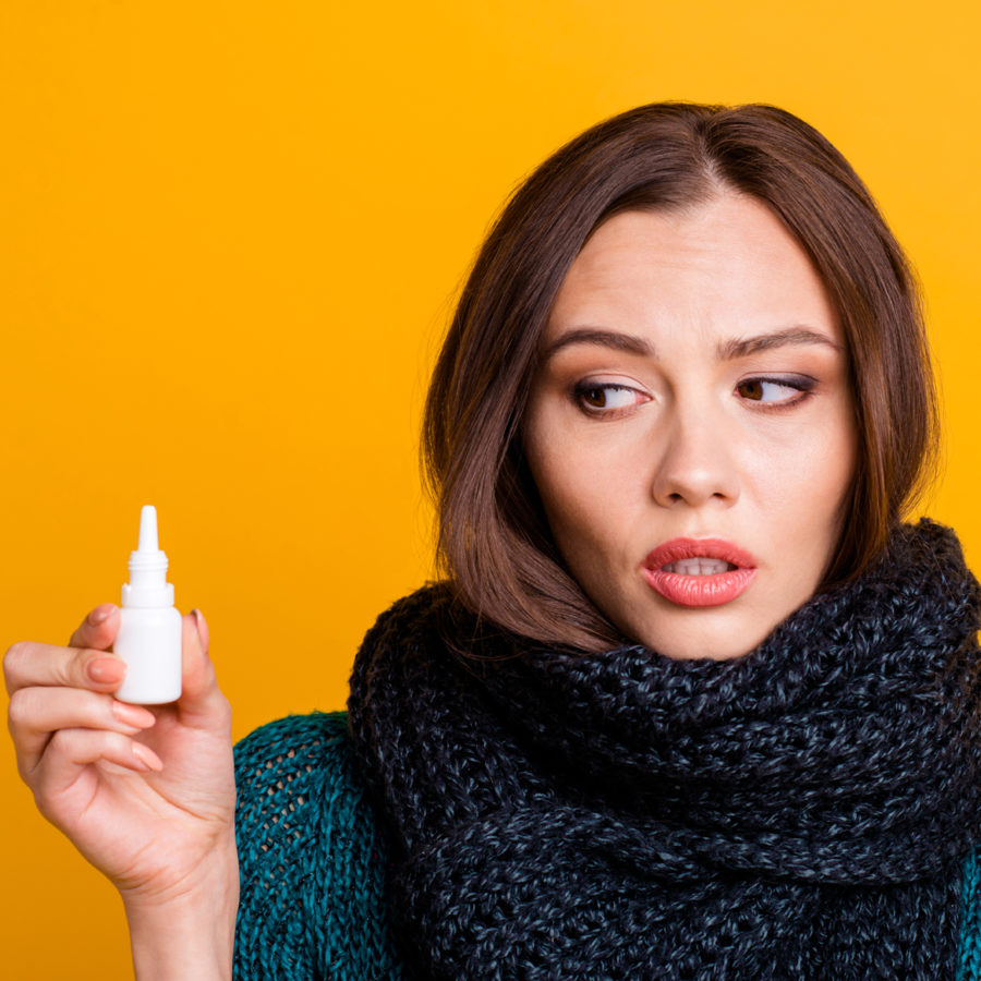POST-NASAL-DRIP-SQ-EDITED Close up photo beautiful amazing her she lady soft warm scarf around neck illness suffering look dripping nasal spray user not sure wear green knitted pullover jumper isolated yellow background
